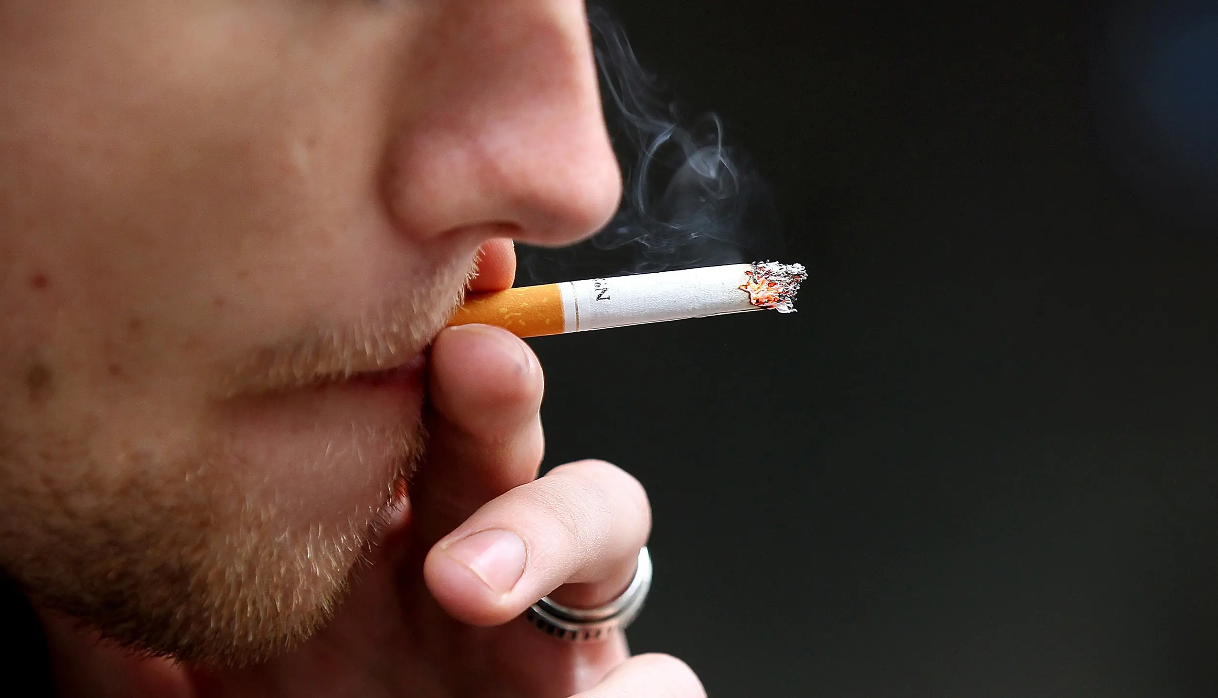 cigarette being smoked - Why do cigarette smokers smoke
